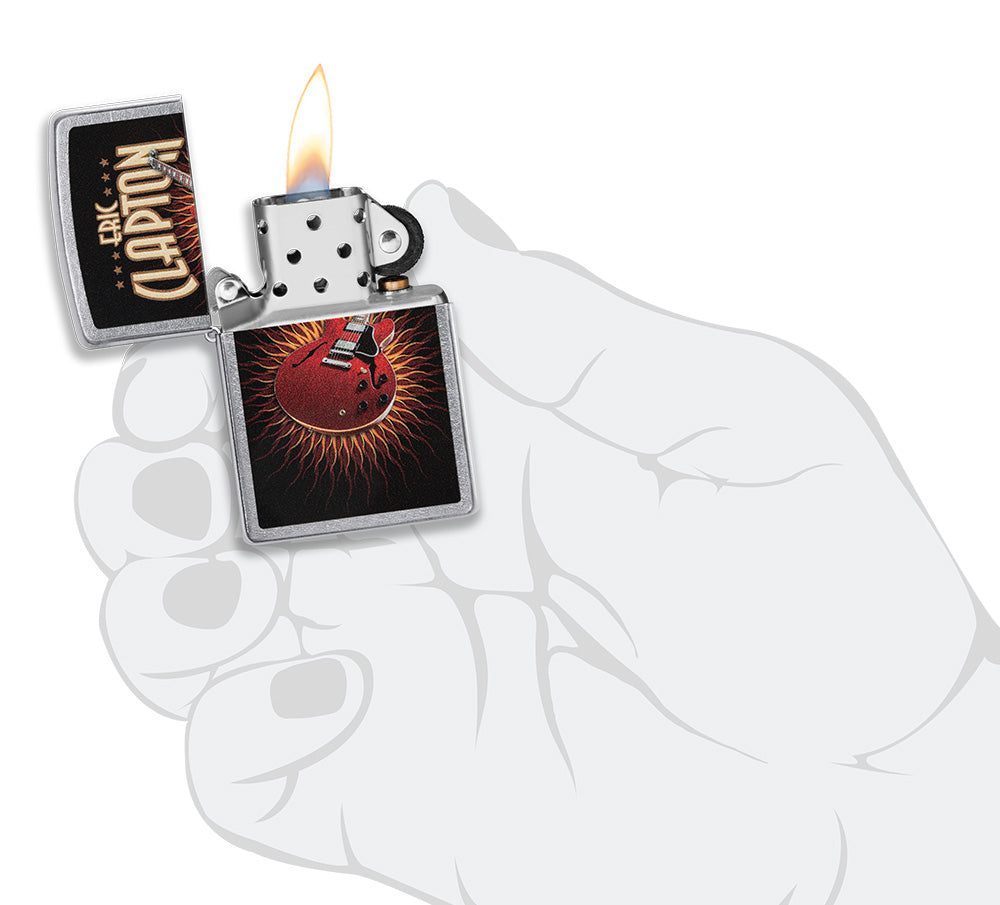Zippo lighter front view chrome open and lit with coloured image of a red guitar of Eric Clapton in stylistic hand