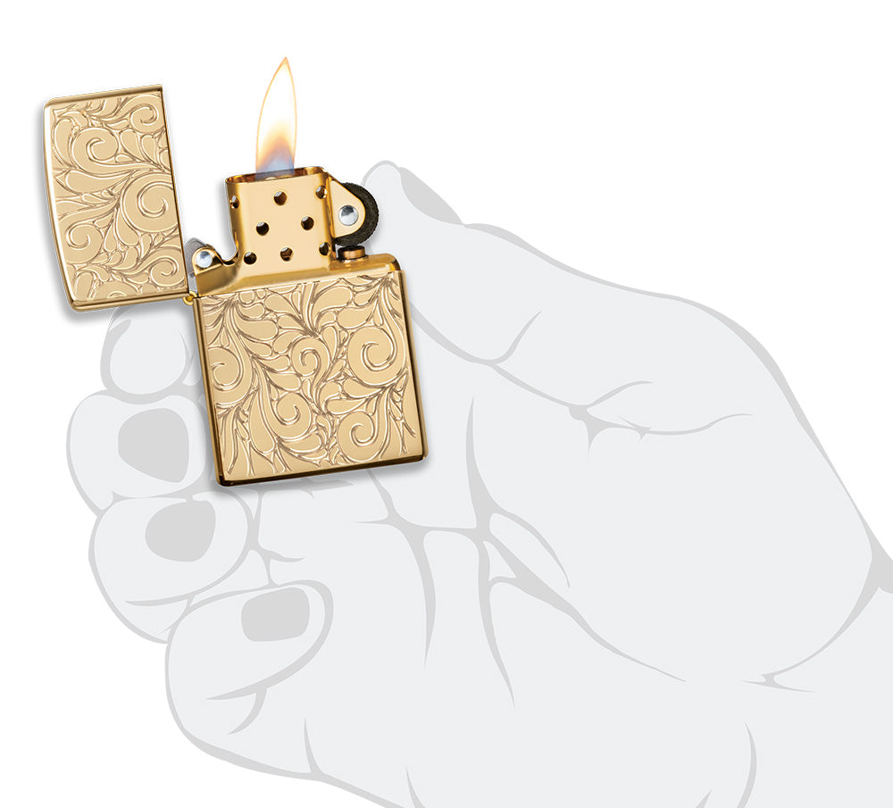 Zippo Lighter Front View Armor® highly polished brass opened and lit with deeply engraved squiggly lines in stylised hand