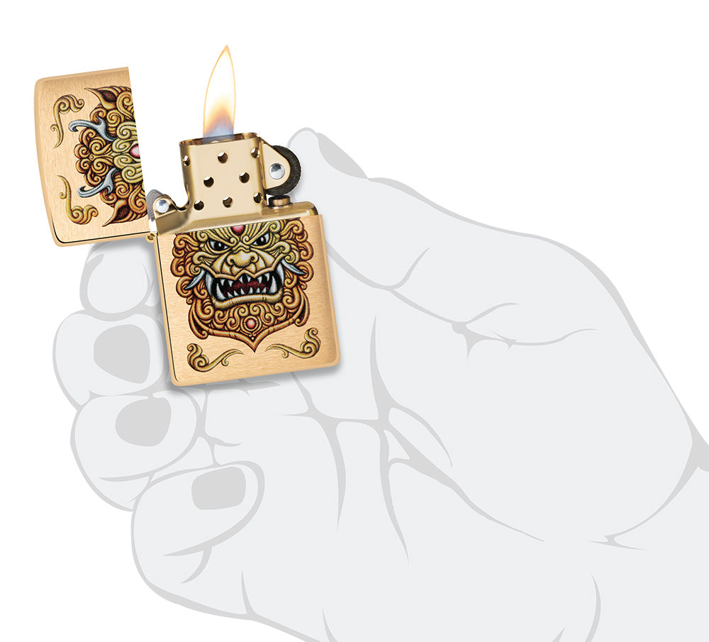 Zippo windproof lighter Foo Dog Design in a hand to represent the size of the lighter, showing an imperial golden lions in the style of chinese art.