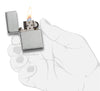 Zippo Lighter 1935 Replica front view opened and lighted in brushed chrome look in stylized hand