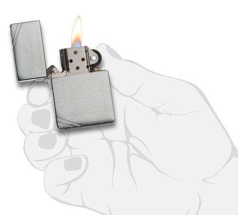 Zippo Lighter 1935 Replica front view opened and lit in brushed chrome look with engraved slashes on opposite corners in stylised hand.