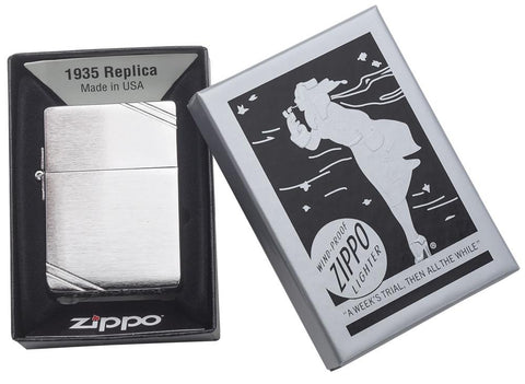 Zippo lighter 1935 replica front view in brushed chrome look with engraved slashes on opposite corners in open black grey gift box