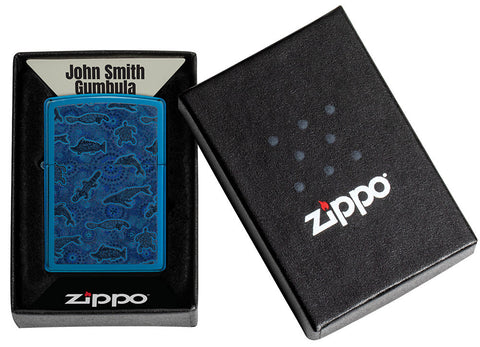 Zippo lighter front view in high gloss blue with illustration of sea creatures in the style of Aboriginal art in open gift box