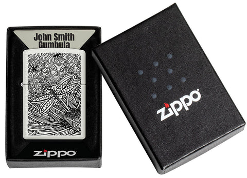 Zippo lighter front view white matt with illustration of a dragonfly in the style of Aboriginal art in open box