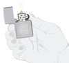 Zippo King Charles Coronation storm lighter in one hand to represent the size of the lighter