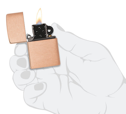 Zippo lighter basic model in brushed solid copper and black insert opened with flame in stylised hand