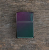 Lifestyle image of Iridescent Zippo Logo Windproof Lighter laying flat on a wooden surface
