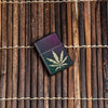 Lifestyle image of Iridescent Marijuana Leaf Windproof Lighter laying on wooden background