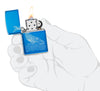  Zippo lighter front view opened and lit Whale Design shiny light blue with an engraved whale with round waves in stylised hand